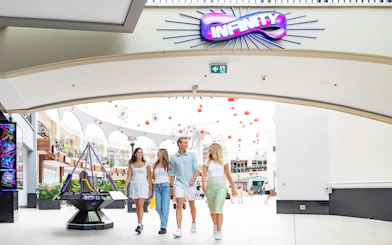 Visitors entering Infinity Attraction at Gold Coast shopping center.