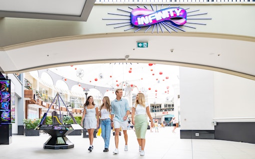 Visitors entering Infinity Attraction at Gold Coast shopping center.
