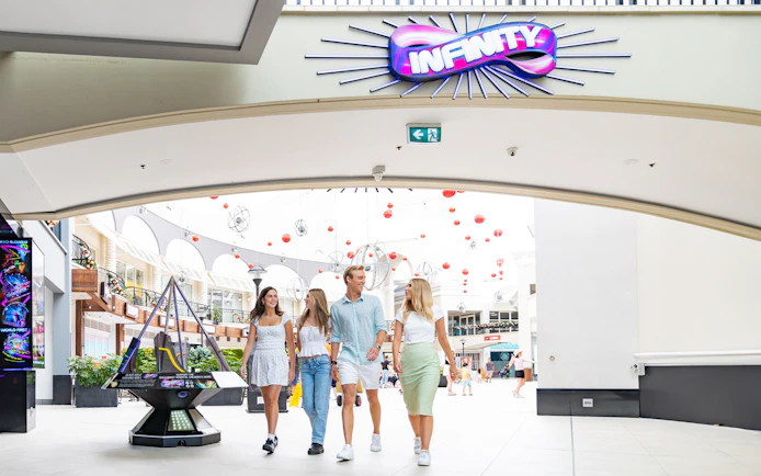 Visitors entering Infinity Attraction at Gold Coast shopping center.