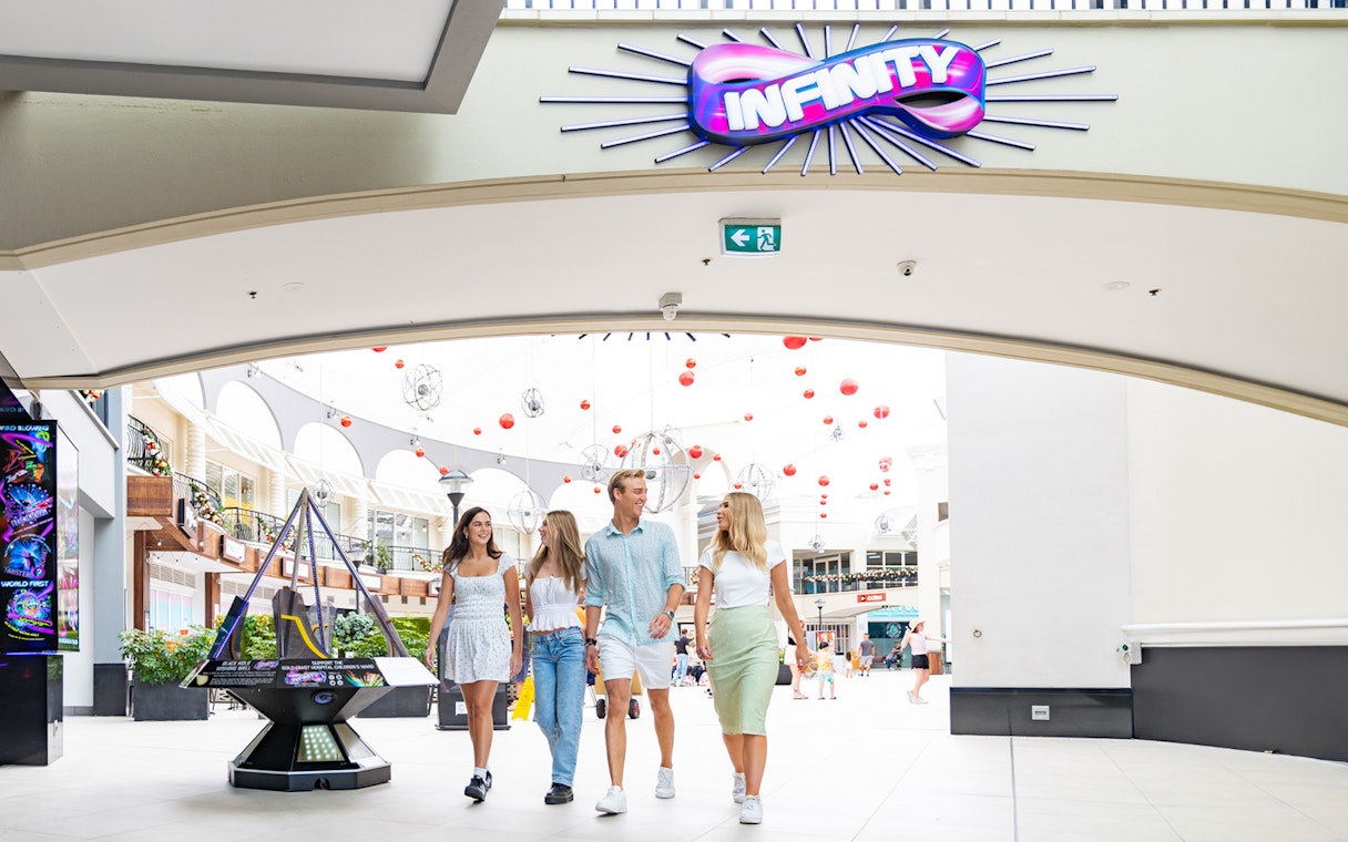 Visitors entering Infinity Attraction at Gold Coast shopping center.