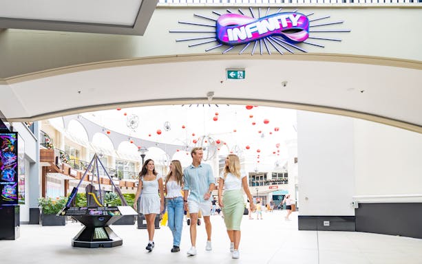 Visitors entering Infinity Attraction at Gold Coast shopping center.