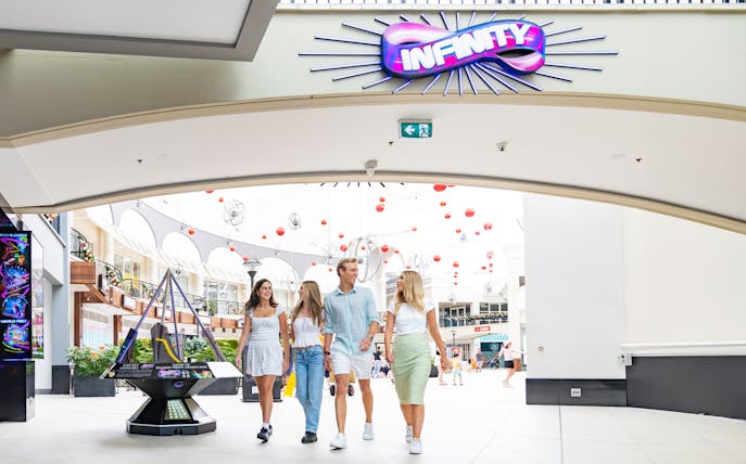 Visitors entering Infinity Attraction at Gold Coast shopping center.