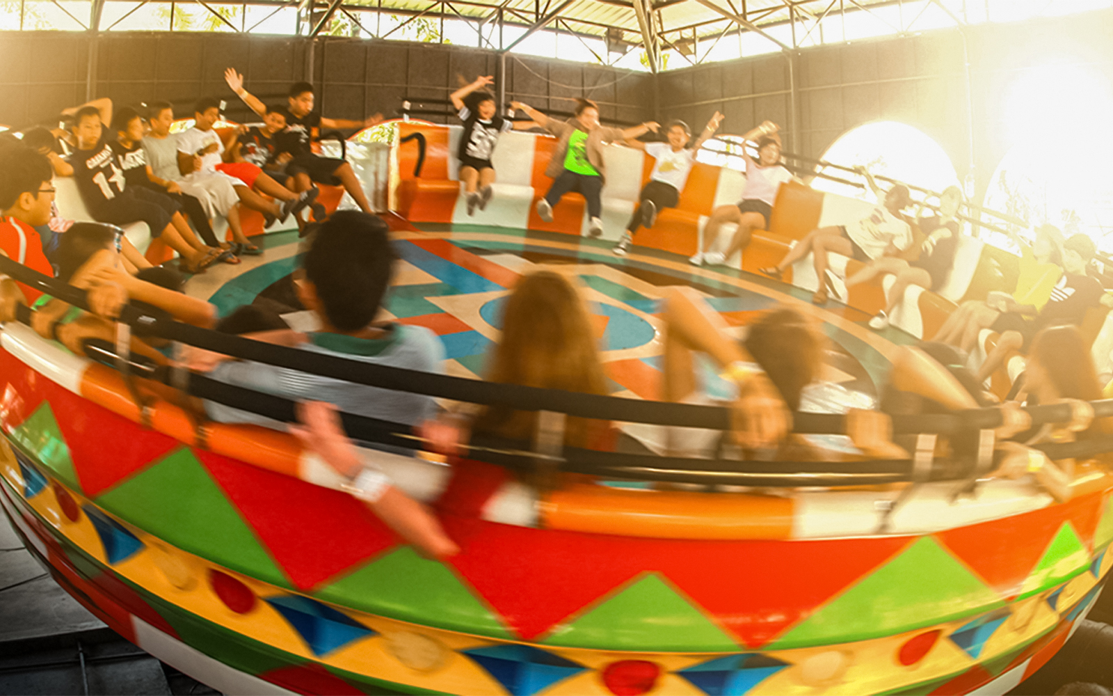 Disco turntable ride at Siam Amazing Park with colorful lights and spinning motion.