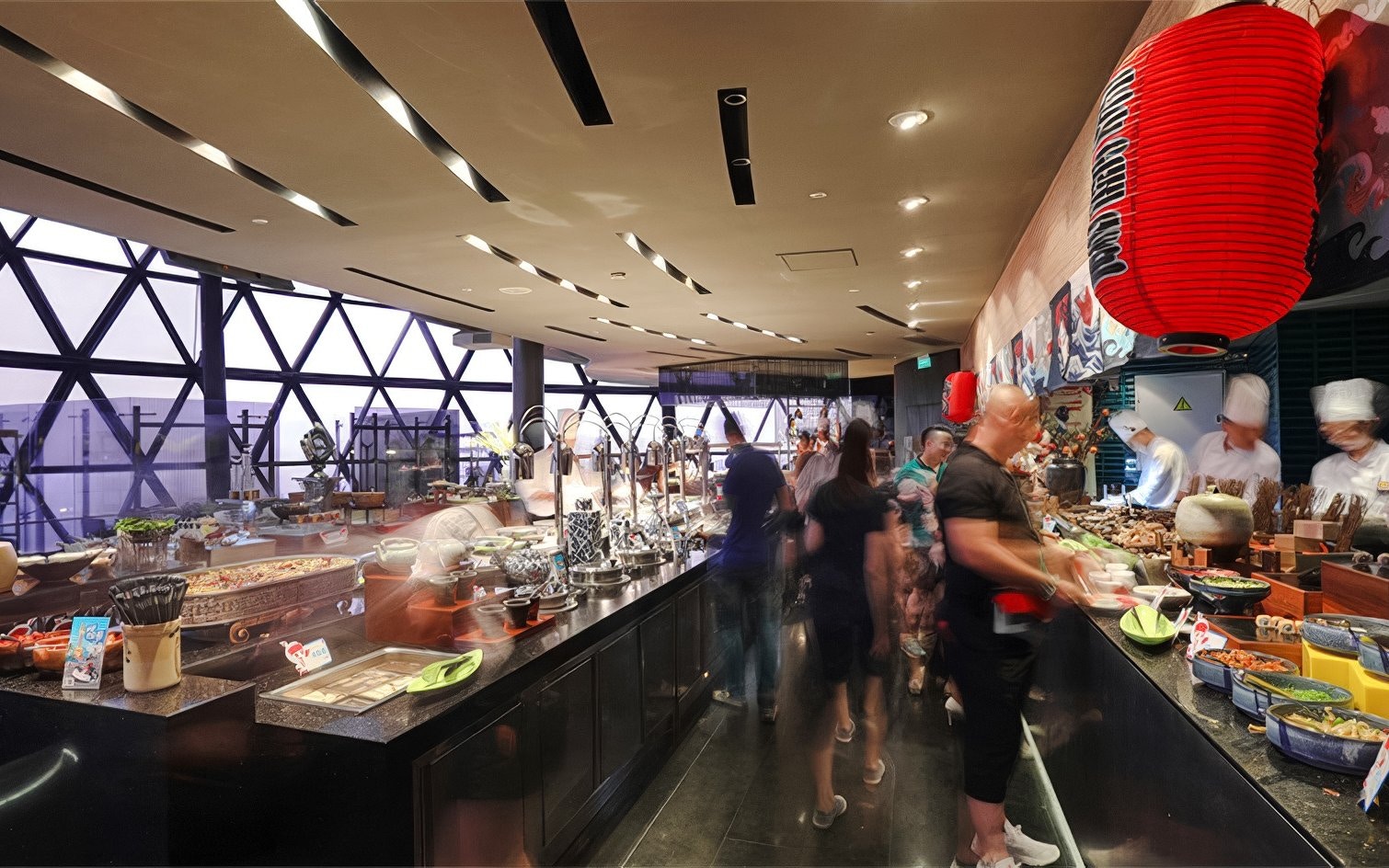 Buffet spread at revolving restaurant, Oriental Pearl Tower, Shanghai, with chefs and diners.