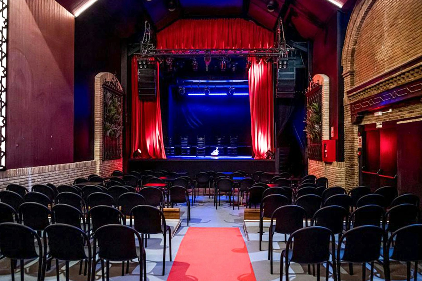 Flamenco theater stage with red curtains and seating, Sensaciones - Teatro Flamenco Granada.
