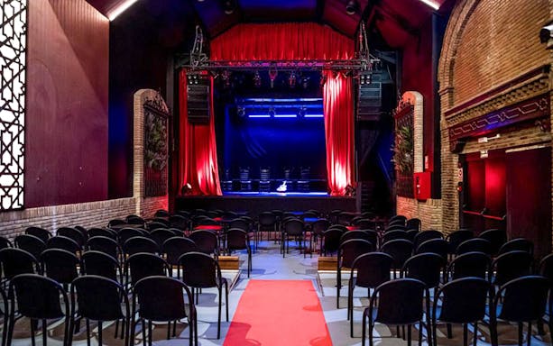 Flamenco theater stage with red curtains and seating, Sensaciones - Teatro Flamenco Granada.