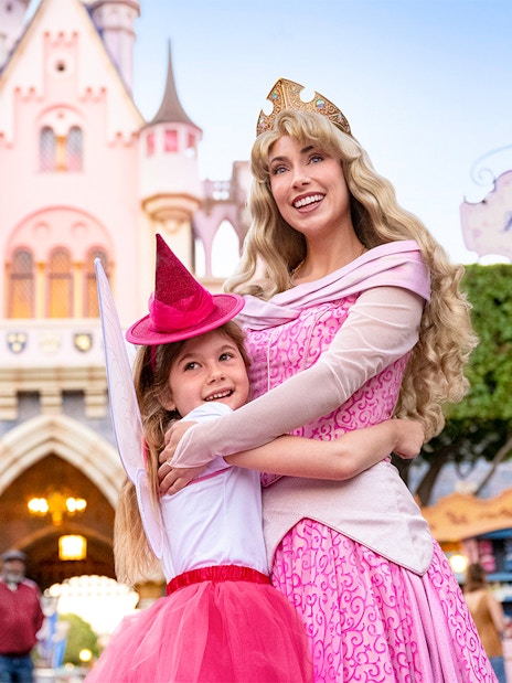 Child meeting a princess in front of Sleeping Beauty Castle, Disneyland Park, California.