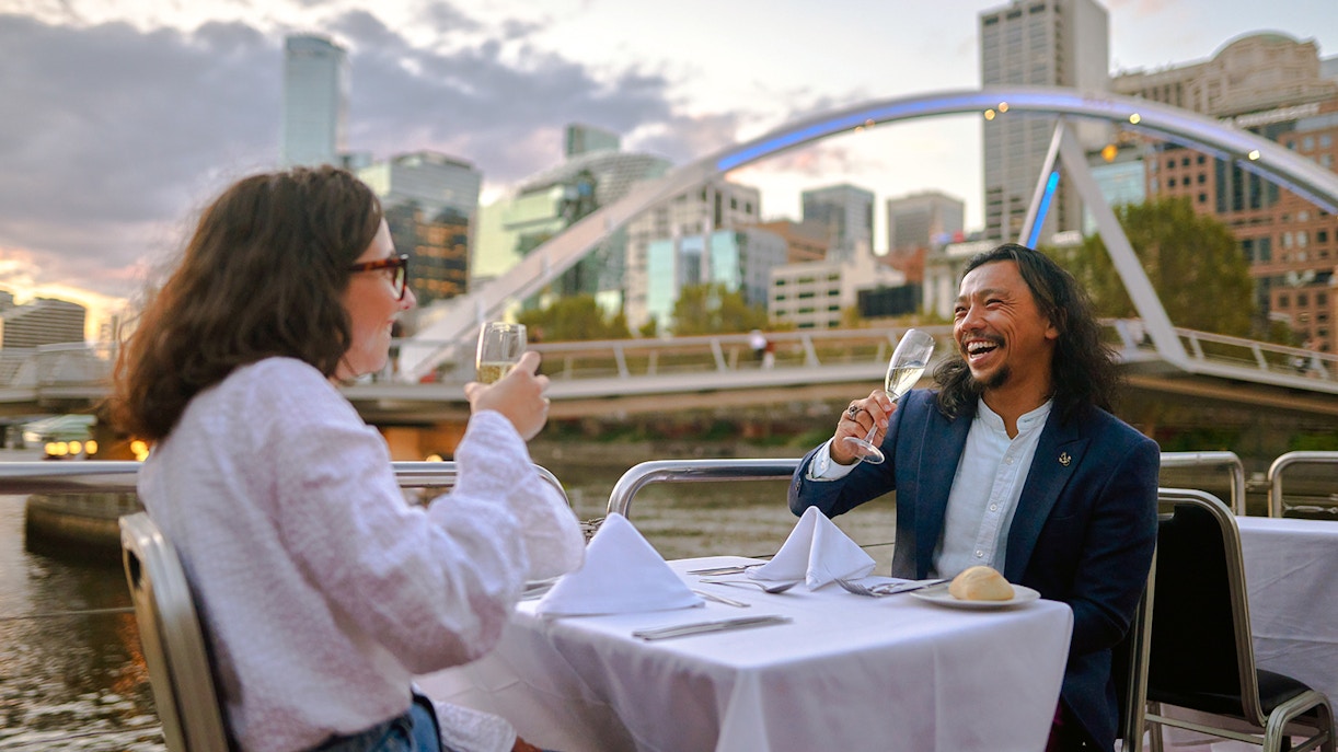 Melbourne river cruise with Carolyn M Pallett, city skyline and sunset in the background.