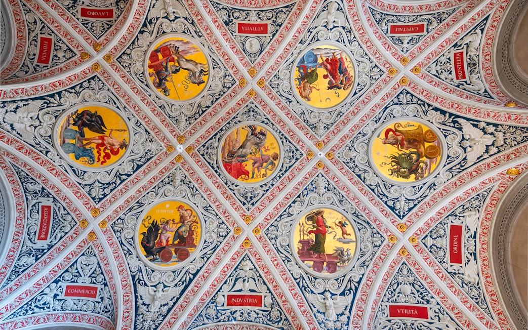 Ceiling frescoes at Palazzo delle Papesse, Siena, featuring intricate circular paintings.