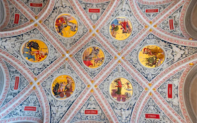 Ceiling frescoes at Palazzo delle Papesse, Siena, featuring intricate circular paintings.