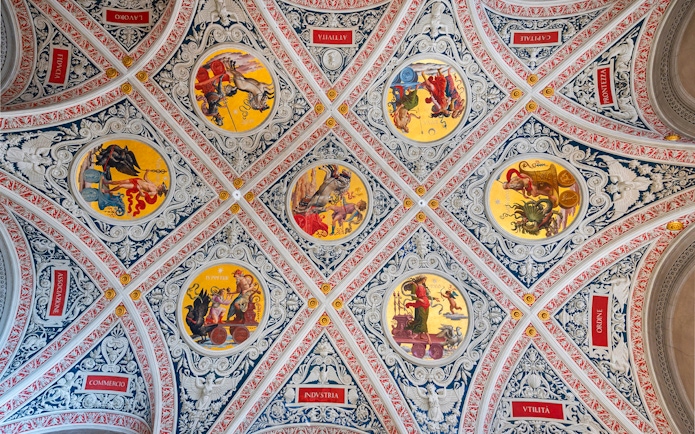 Ceiling frescoes at Palazzo delle Papesse, Siena, featuring intricate circular paintings.