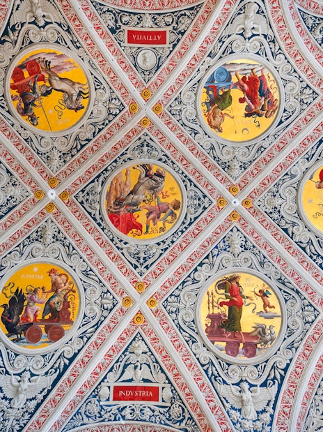 Ceiling frescoes at Palazzo delle Papesse, Siena, featuring intricate circular paintings.