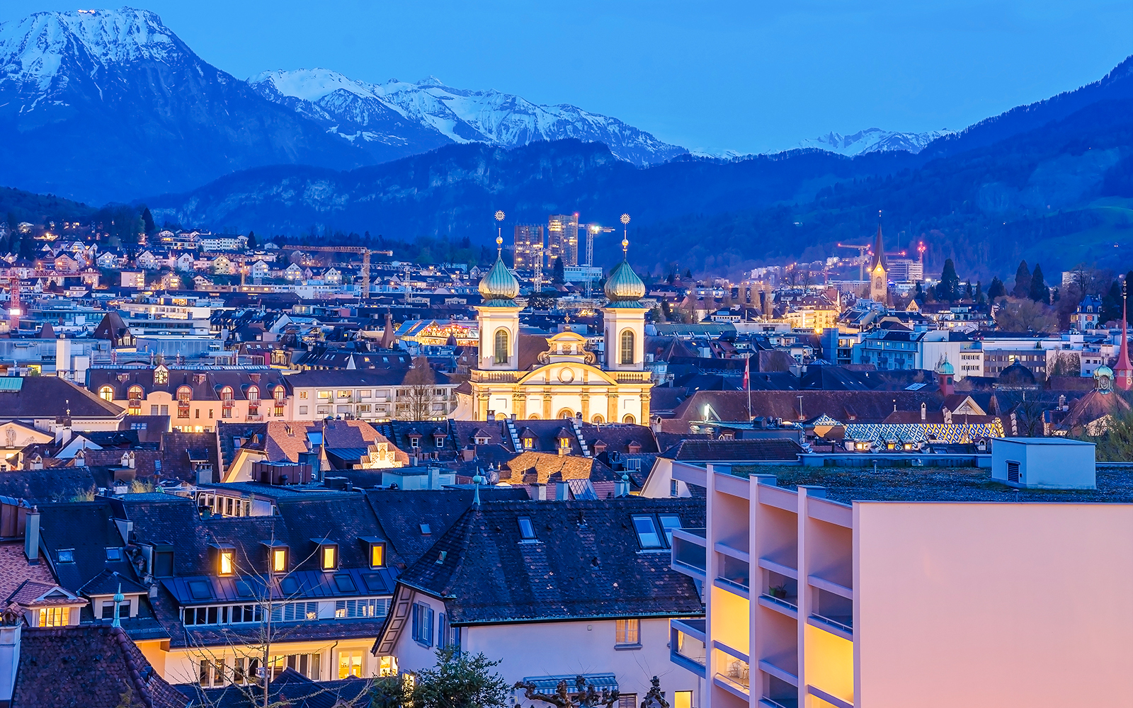 Lucerne Old Town and Lake Lucerne with Christmas lights, Switzerland, at dusk.