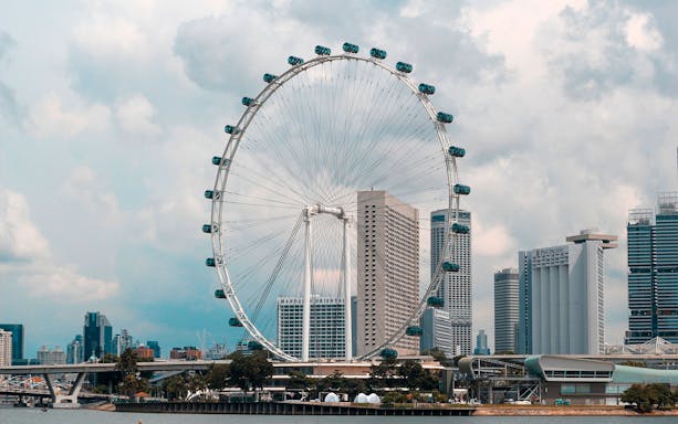 Singapore Flyer with city skyline in the background, viewed from Marina Bay.