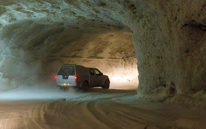 Vehicle driving through Slanic Salt Mine tunnel near Bucharest.