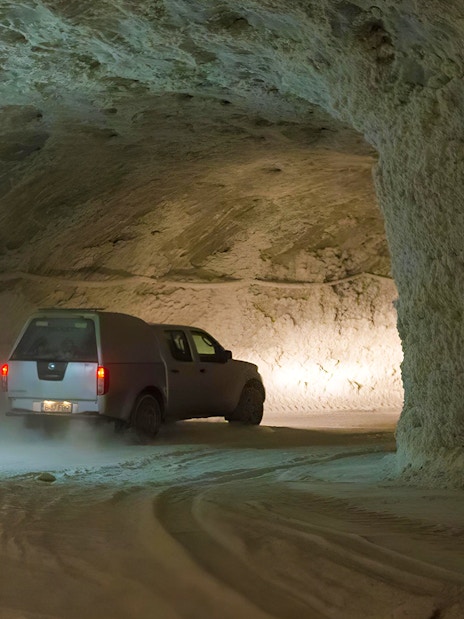 Vehicle driving through Slanic Salt Mine tunnel near Bucharest.