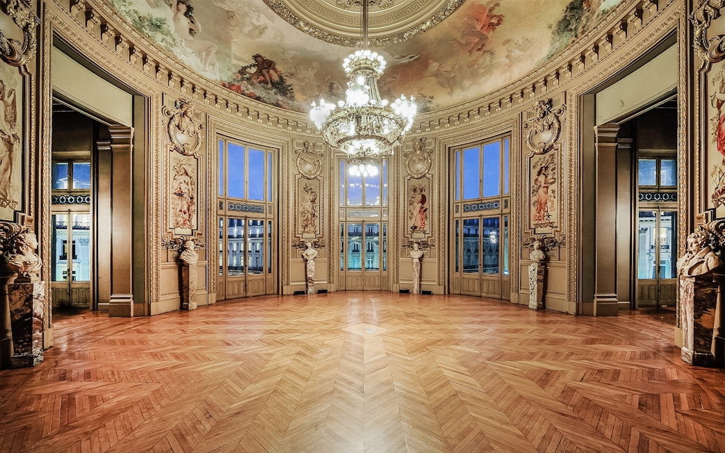 Opéra Garnier interior with ornate ceiling and chandelier, Paris.