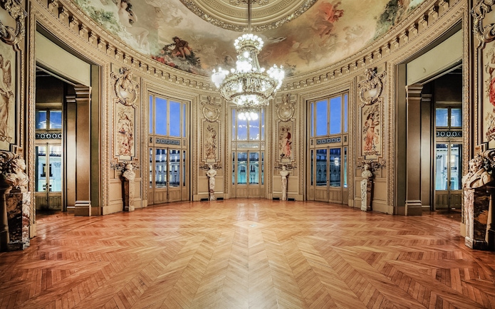 Opéra Garnier interior with ornate ceiling and chandelier, Paris.