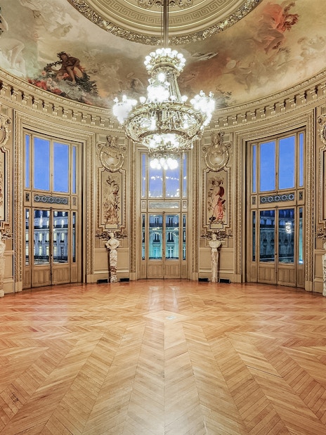 Opéra Garnier interior with ornate ceiling and chandelier, Paris.