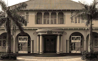 Durban Local History Museum entrance with palm trees, part of Half Day Durban City Sightseeing Tour.