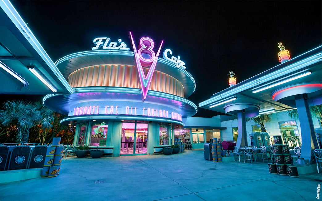 Flo's Cafe neon-lit exterior at Disneyland Adventure Park, California.