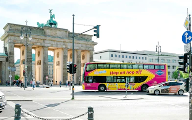 City circle bus passing by the Brandenburg Gate in Berlin.