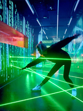 Person navigating laser maze at German Spy Museum, Berlin.
