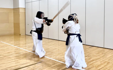 Participants practicing kendo in a dojo during a samurai experience in Sapporo.