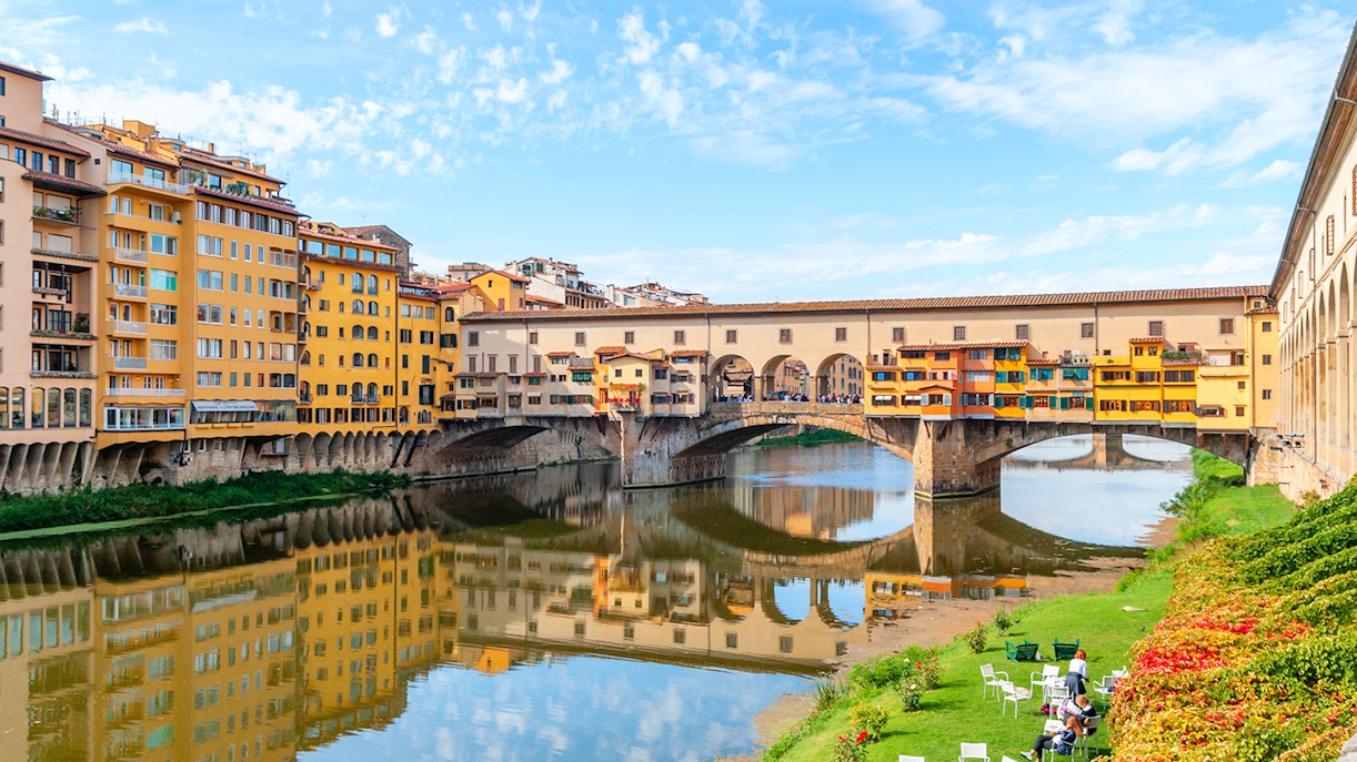 Ponte Vecchio bridge over the Arno River in Florence, Italy, with colorful buildings.