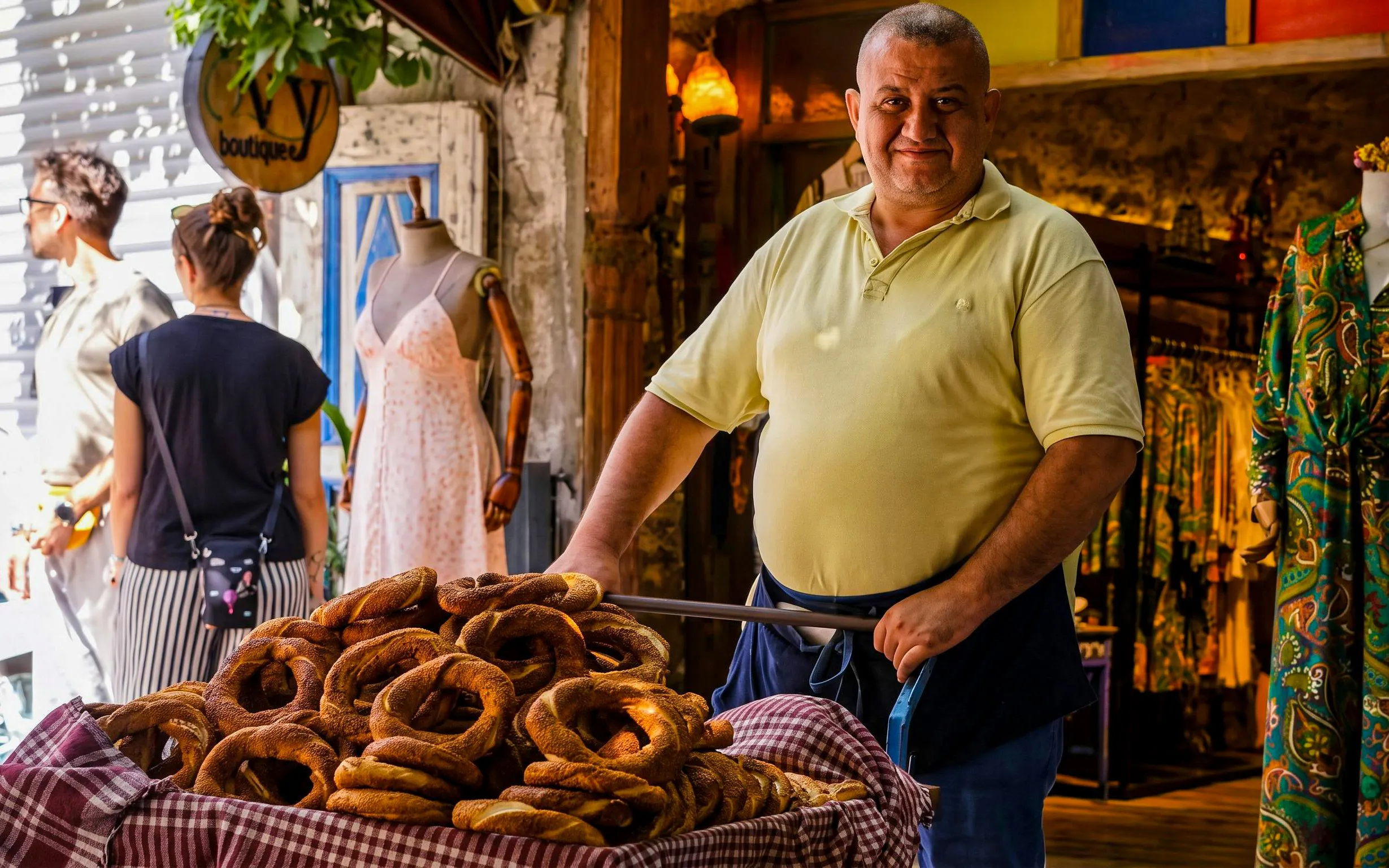 Man selling simit on Istanbul street during food tour.