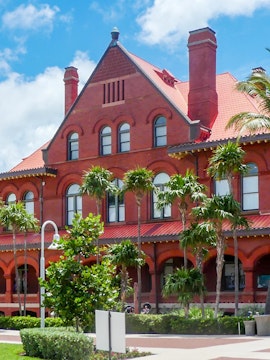 St. Augustine History Museum red brick building with palm trees in front.