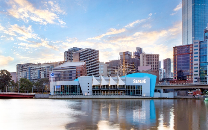 Sea Life Melbourne Aquarium exterior with city skyline in the background.