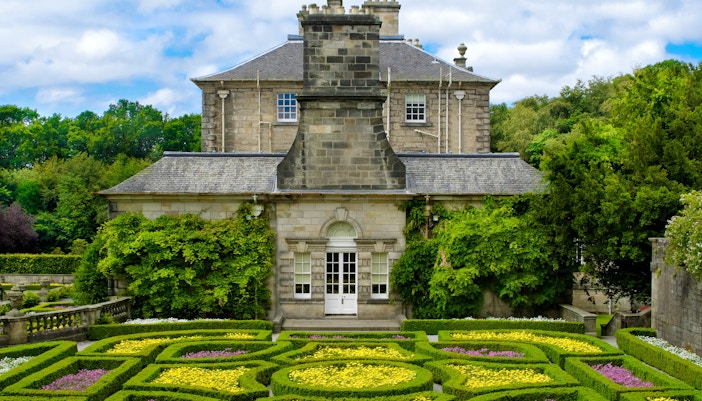 Pollok Country Park garden with historic stone building in Glasgow.