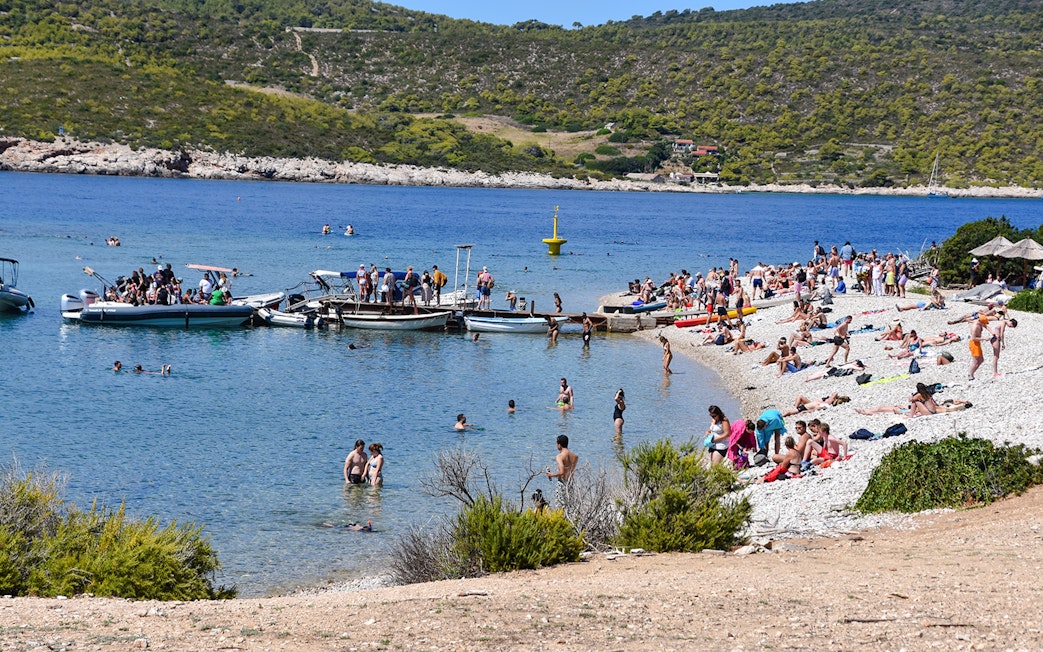 Visitors enjoying the beach and boats at Budikovac Island's Blue Lagoon.