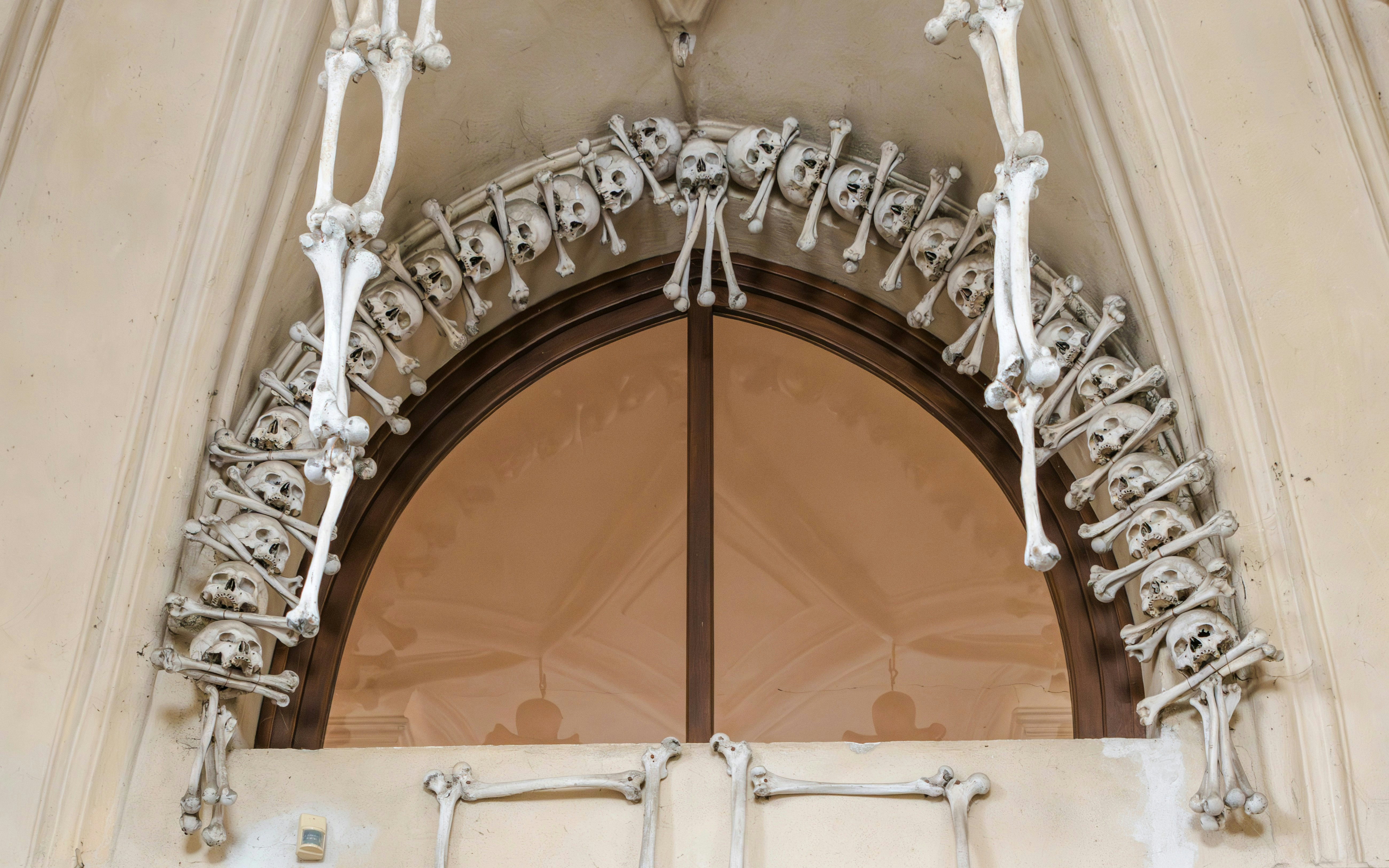 Angels and cross skeletal decoration at Sedlec Ossuary, Czech Republic.