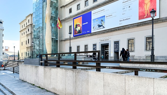 Visitors exploring the modern art exhibits at the Reina Sofia Museum in Madrid, Spain