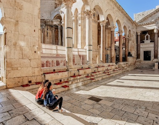 Two women viewing Diocletian's palace in Split, Croatia.