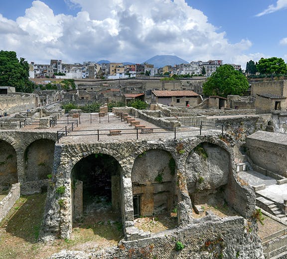 Ancient ruins of Herculaneum with Mount Vesuvius in the background, Italy.