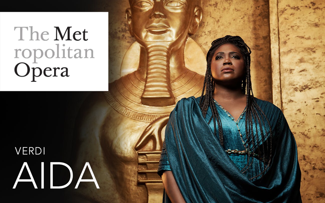 Aida at the Metropolitan Opera with Egyptian statue backdrop.