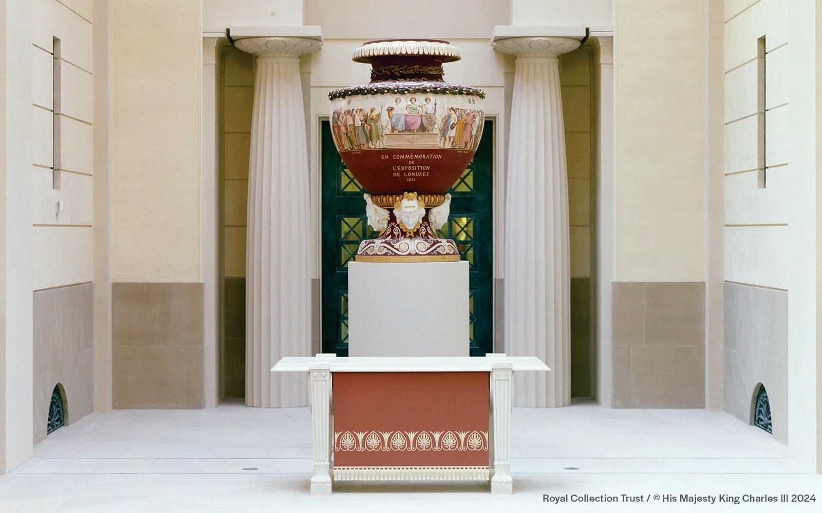 Decorative urn in Buckingham Palace with classical columns in the background.