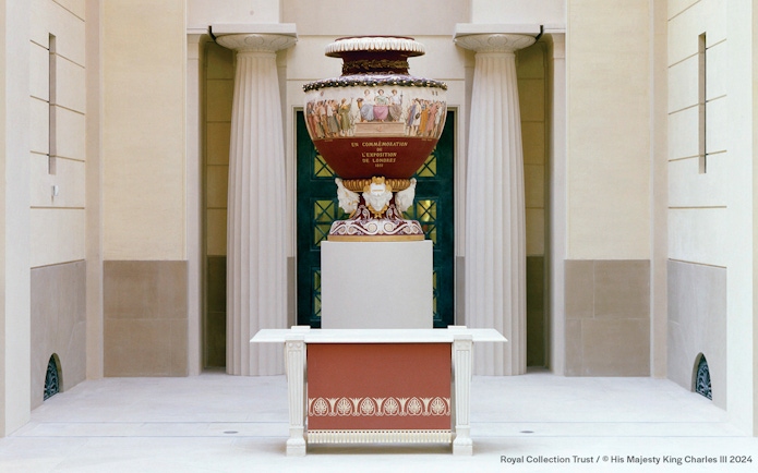 Decorative urn in Buckingham Palace with classical columns in the background.
