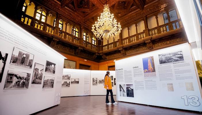 Visitors exploring art exhibition inside Poble Espanyol