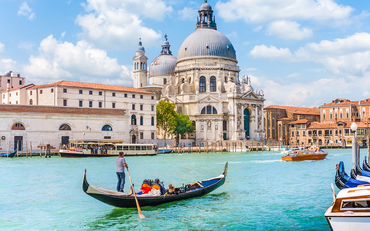 Gondola on Venice canal near St. Mark's Basilica during guided tour.