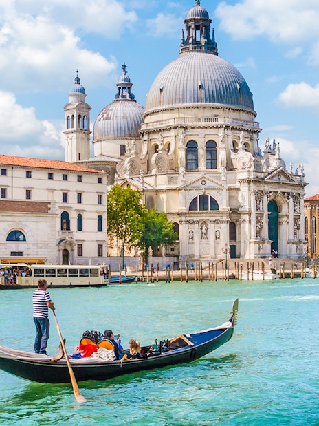 Gondola on Venice canal near St. Mark's Basilica during guided tour.