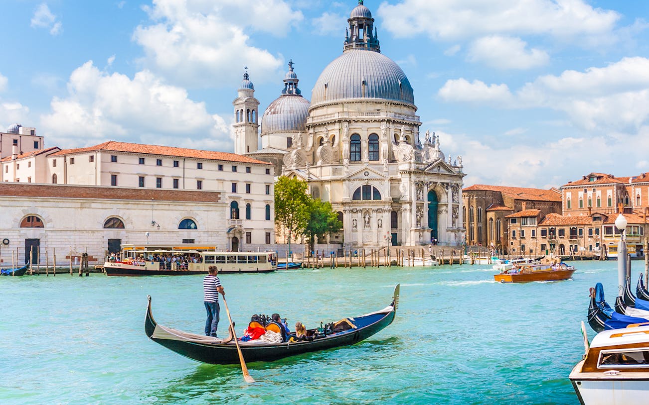 Gondola on Venice canal near St. Mark's Basilica during guided tour.