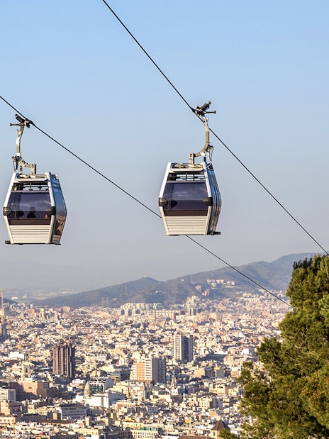Cable car ascending Montjuic Hill with Sagrada Familia in background, Barcelona.