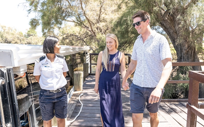 Couple walking with guide on Swan Valley Wine Cruise dock.