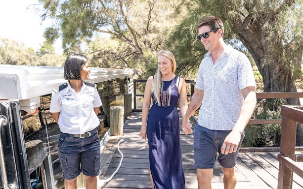 Couple walking with guide on Swan Valley Wine Cruise dock.