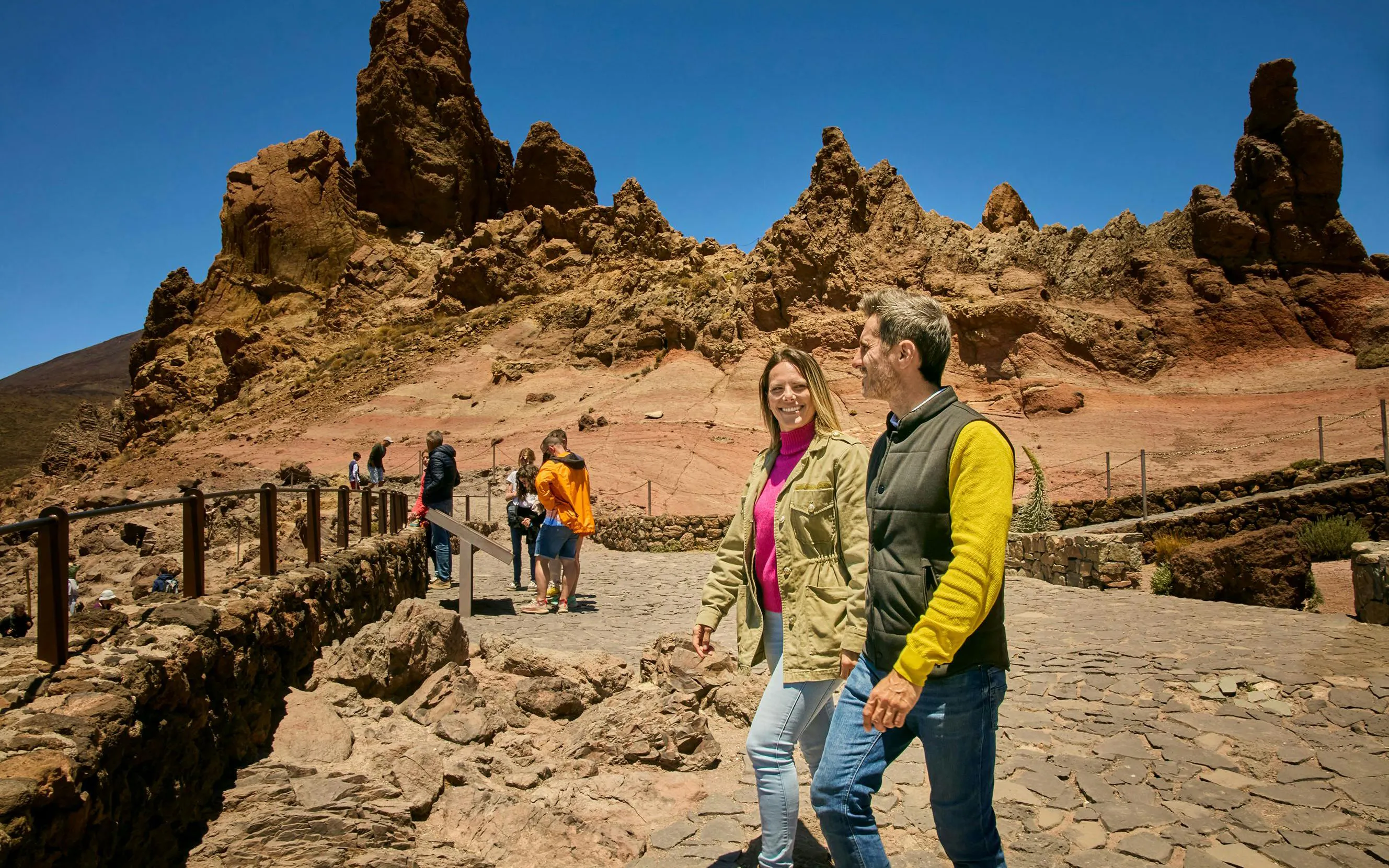 Guests walking on Mount Teide guided tour with rocky landscape in Tenerife.