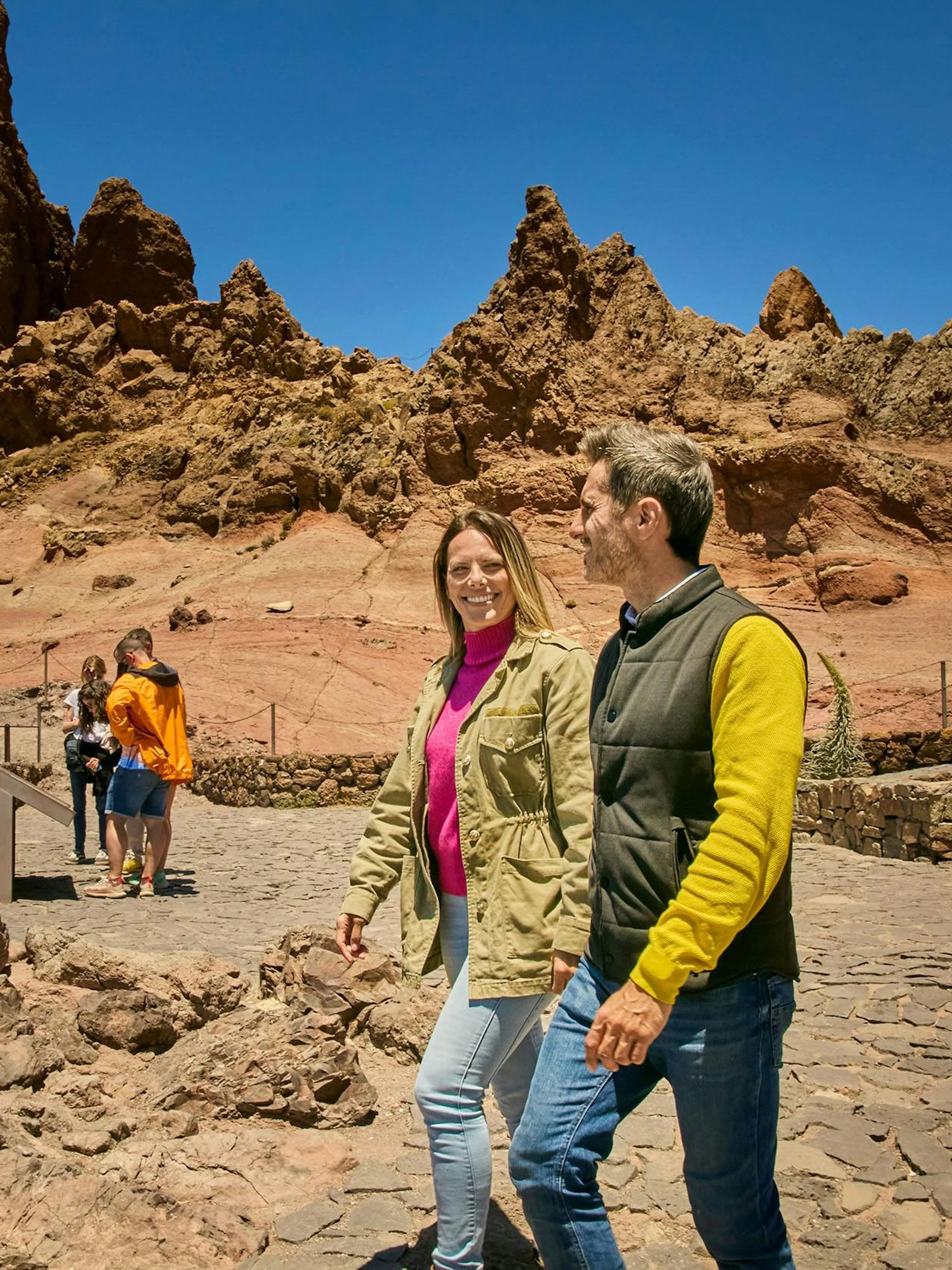 Guests walking on Mount Teide guided tour with rocky landscape in Tenerife.